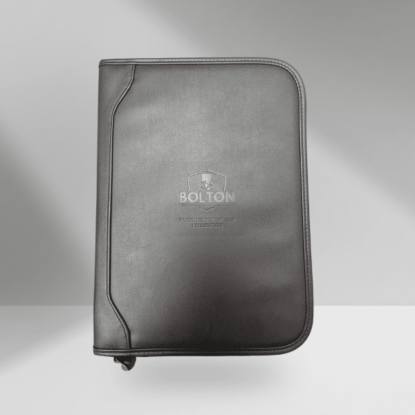 Stay organized in style with this professional leather-bound journal featuring the Bolton Empowerment Foundation logo. Includes a plain 50-sheet writing pad and convenient interior pockets for business cards, notes, and essentials. Your purchase makes an impact. Every item from our store helps fund mentorship, education, and wellness programs for youth in foster care and individuals facing breast cancer.